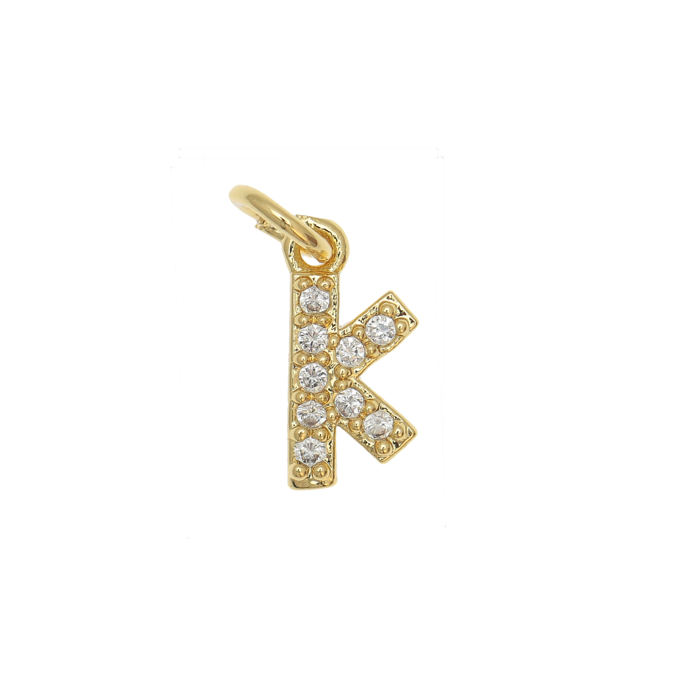Ciondolo a forma di lettera "K", 9x4 mm., strass colore Crsytal, base colore Oro Lucido
