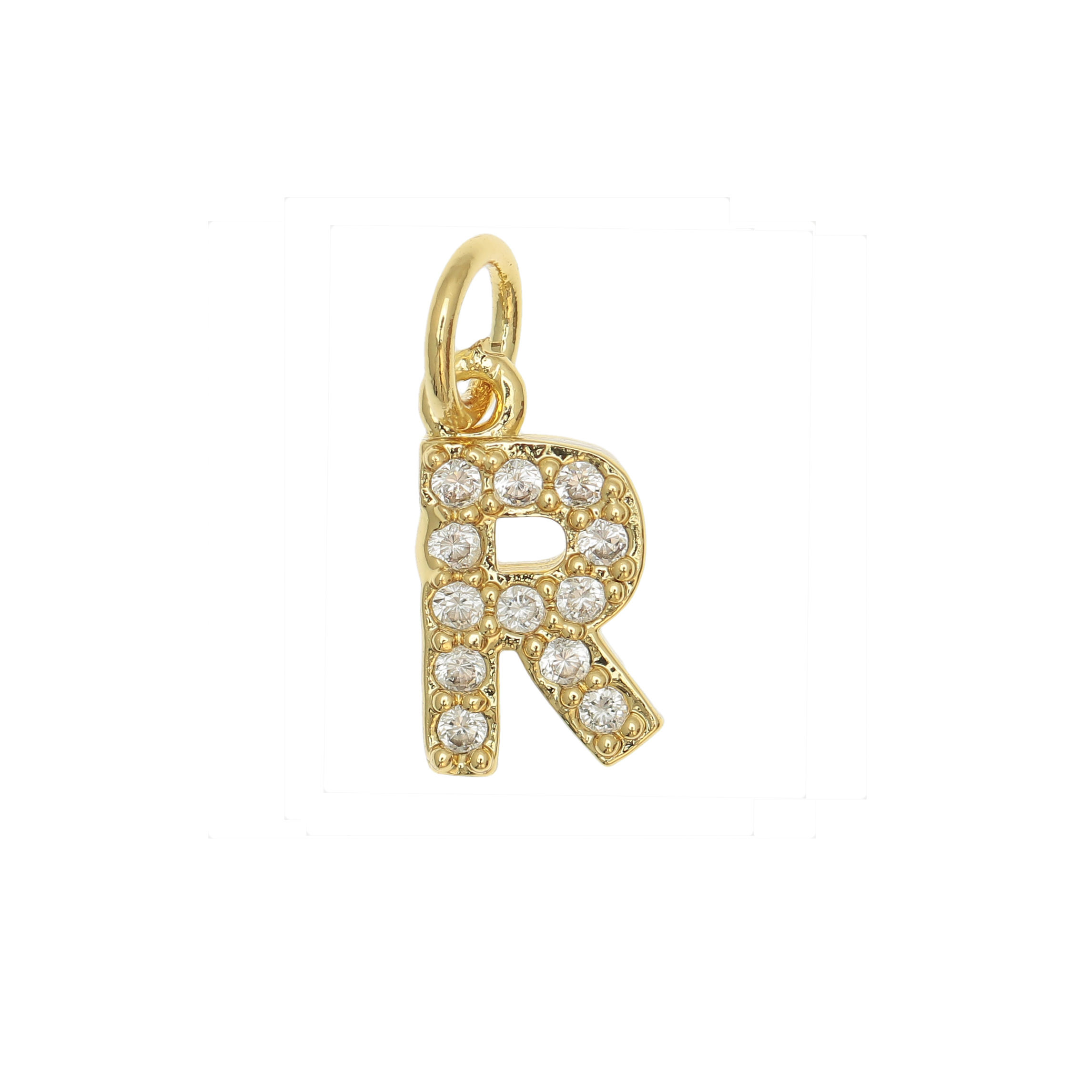 Ciondolo a forma di lettera "R", 9x5 mm., strass colore Crsytal, base colore Oro Lucido