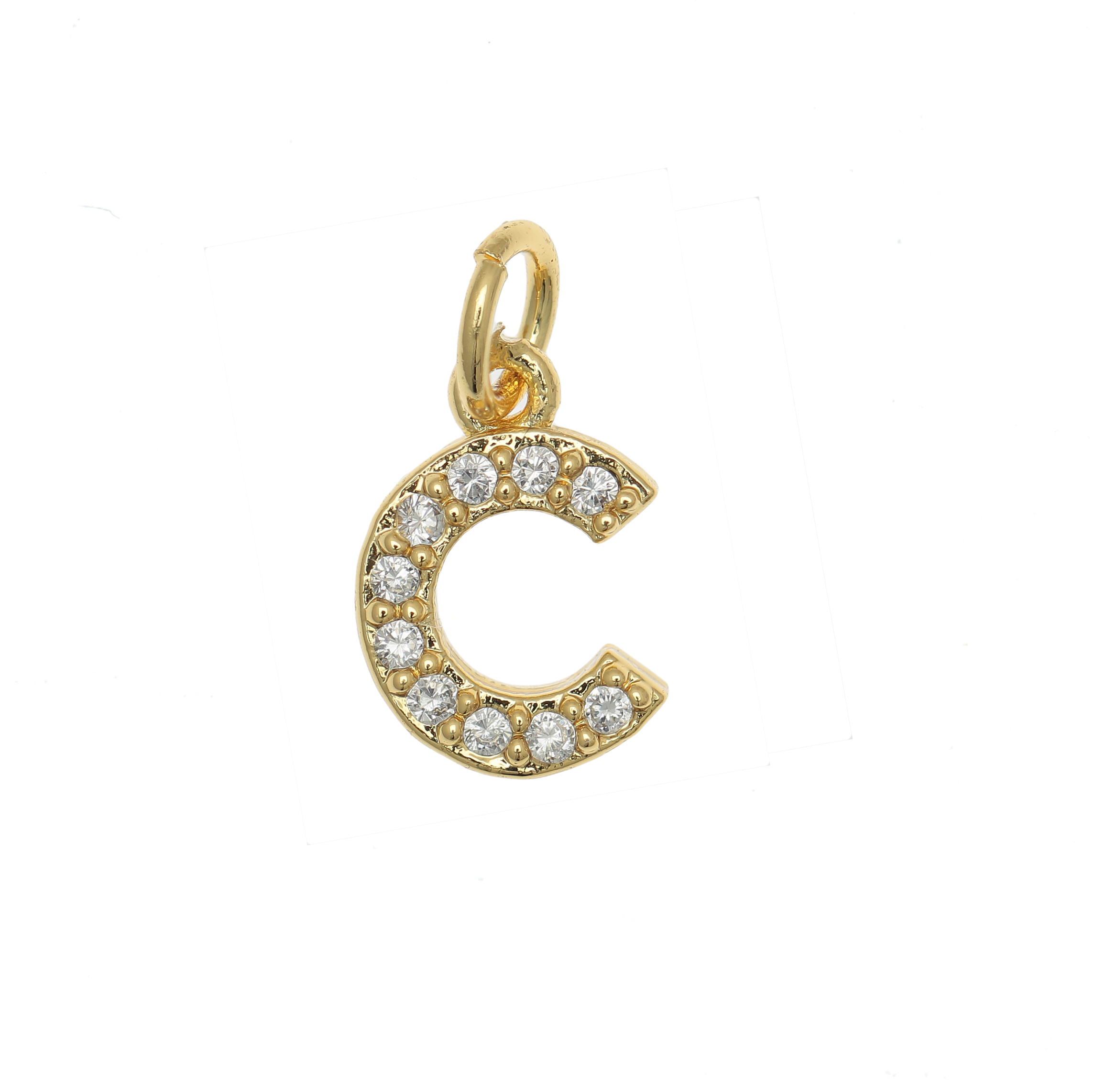 Ciondolo a forma di lettera "C", 9x6 mm., strass colore Crsytal, base colore Oro Lucido