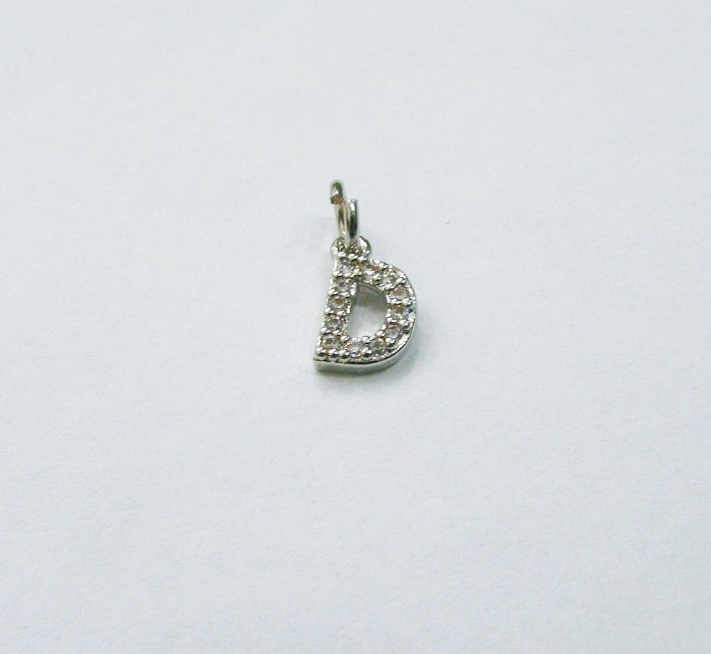 Ciondolo a forma di lettera "D", 9x5 mm., strass colore Crystal, base colore Argento Rodio